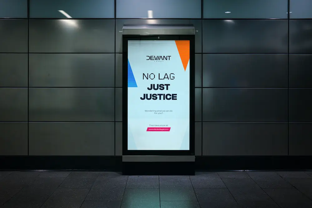 Digital billboard in a subway station displaying Deviant Legal’s ad with the slogan “No lag, just justice.”